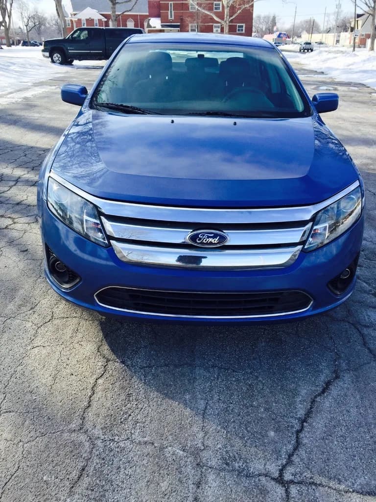 Blue Ford Fusion sedan after collision and body repair at Jack's