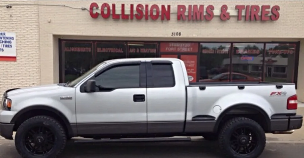 Silver Ford F-150 with matte black custom wheels in front of Jack's Fort Street storefront